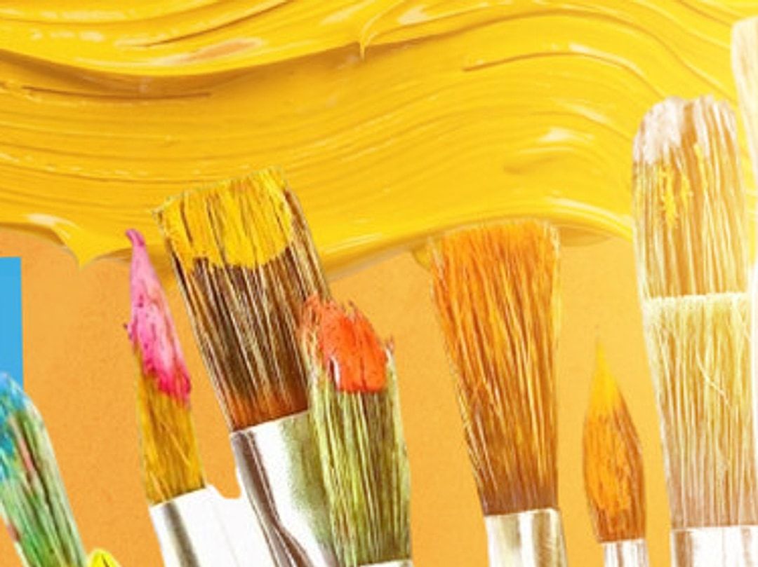 Pinceles con pintura amarilla, rosada y naranja